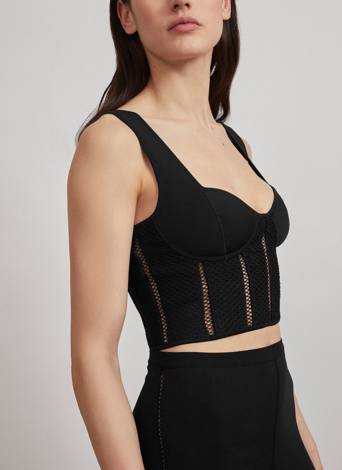 Cropped bustier in technical knit ALAÏA BLACK CROPPED BUSTIER IN TECHNICAL KNIT